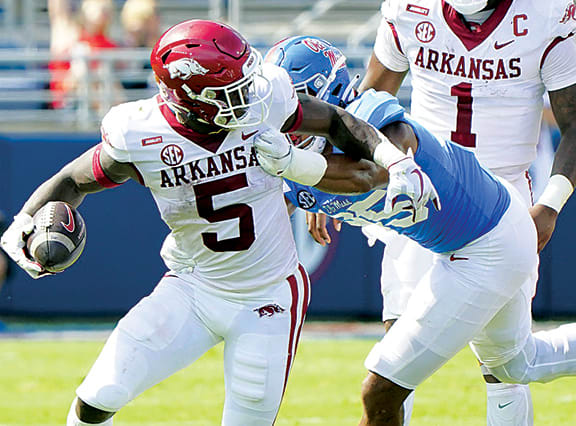 Arkansas Razorbacks running back Raheim Sanders (5) is grabbed from behind by Mississippi Rebels defensive lineman Tavius Robinson (95) at Vaught-Hemingway Stadium.